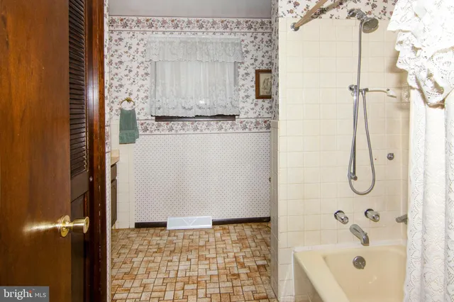 a front view of a house with a garden and plants