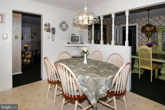 a view of a dining room with furniture and chandelier
