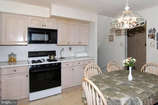 a kitchen with stainless steel appliances granite countertop a kitchen island a stove and a sink