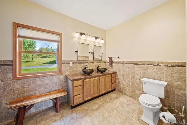 a spacious bathroom with a toilet sink and mirror