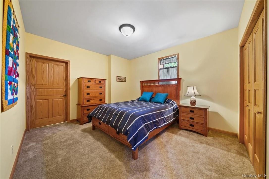 1038 Milanville Road Beach Lake, PA 18405 - Photo 19 of 36 a bedroom with a bed and cabinets