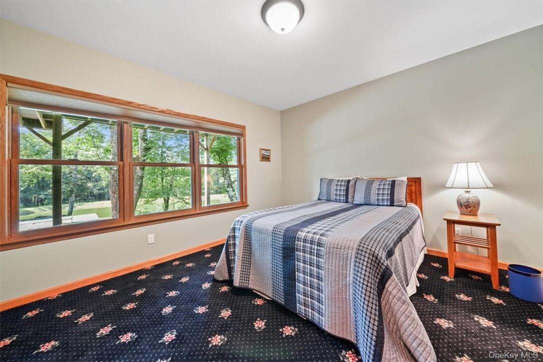 1038 Milanville Road Beach Lake, PA 18405 - Photo 20 of 36 a bedroom with a bed and a window