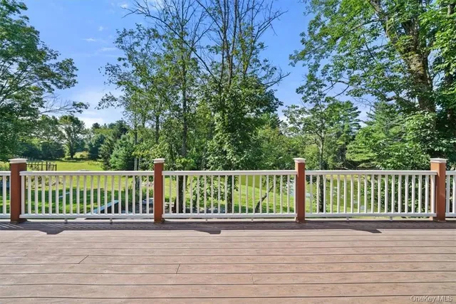 a view of balcony with wooden floor and fence