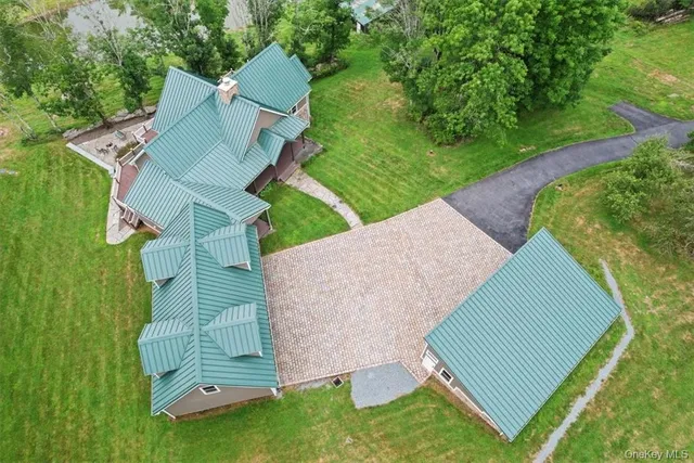 an aerial view of residential house with outdoor space and swimming pool