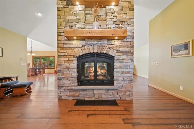a living room with furniture a fireplace and a chandelier