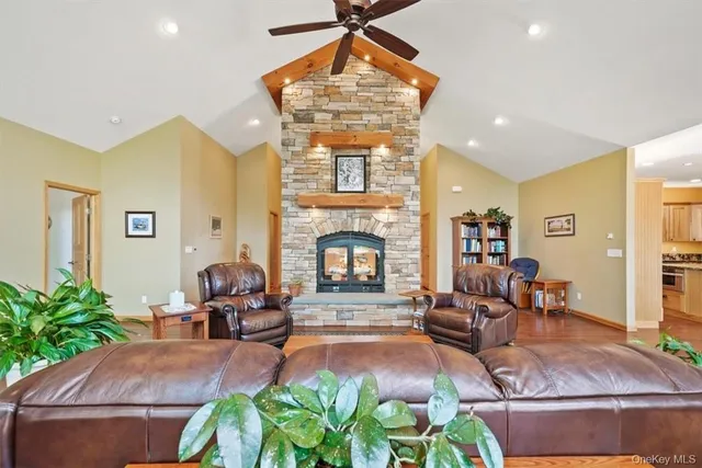 a living room with fireplace furniture and a large window