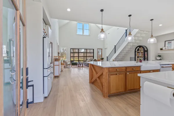 a kitchen with stainless steel appliances kitchen island a large island in the center