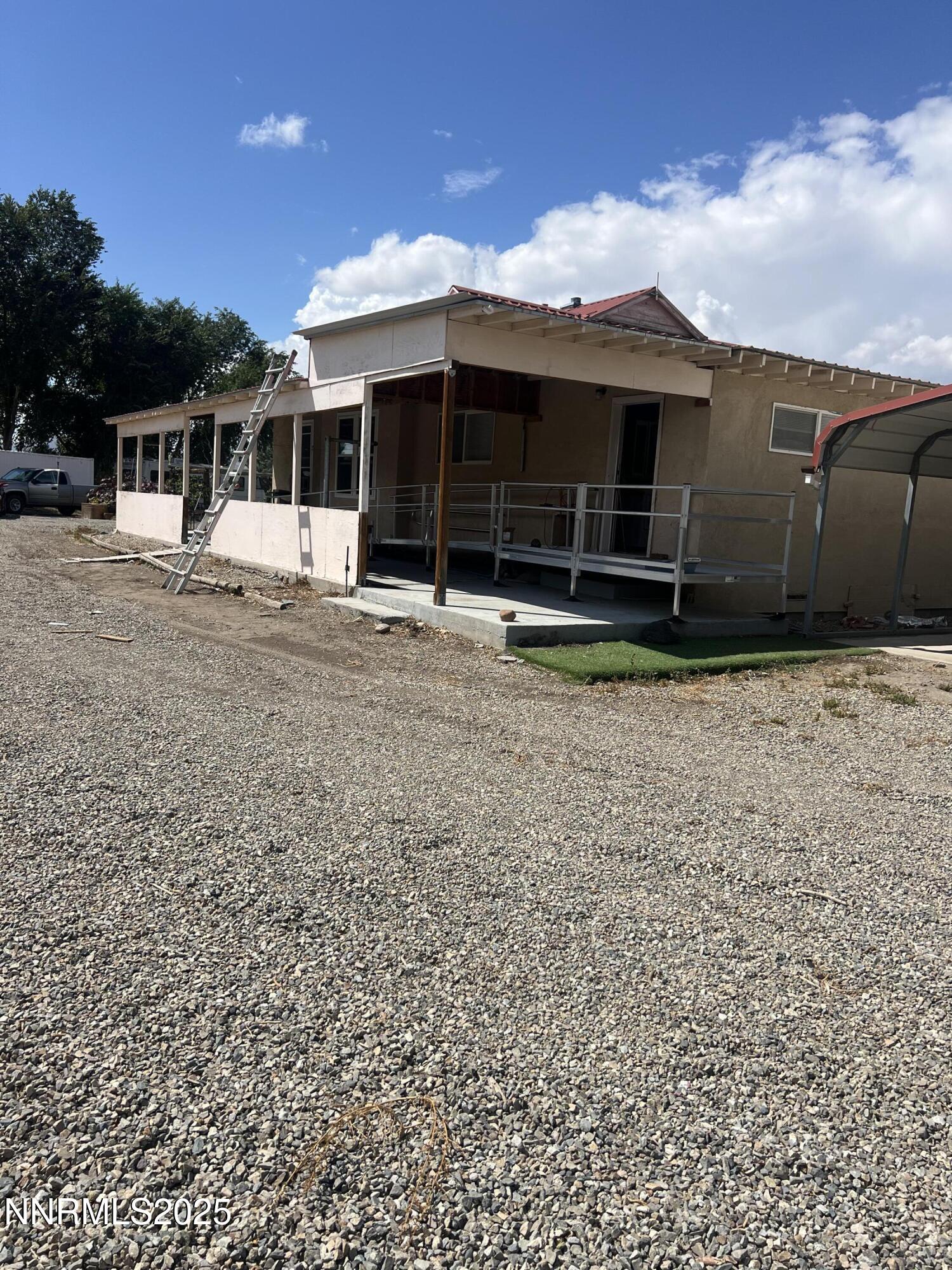 16 Tucker Lane Yerington, NV 89447 - Photo 11 of 12 a view of a house with a large window and a yard