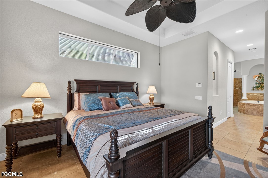 6109 Calusa Rdg Trail Bokeelia, FL 33922 - Photo 27 of 48 a bedroom with a bed and a chandelier