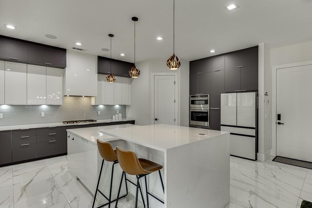 741 Rock Springs Road, Unit 3 Lawrenceville, GA 30043 - Photo 16 of 53 a large kitchen with stainless steel appliances kitchen island granite countertop a table and chairs in it