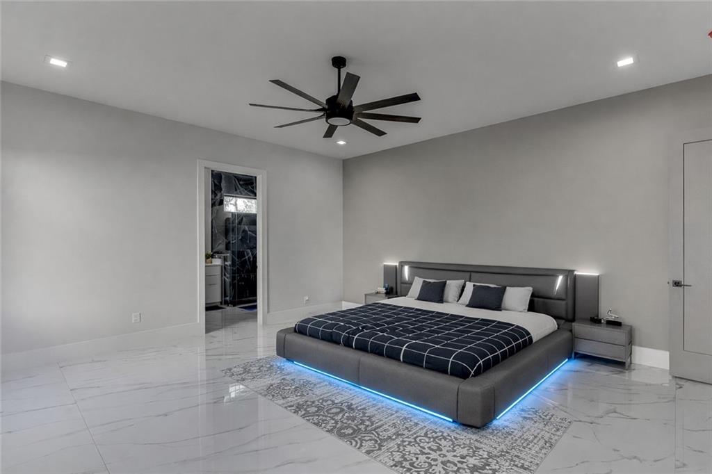 741 Rock Springs Road, Unit 3 Lawrenceville, GA 30043 - Photo 22 of 53 a bedroom with a large bed and a chandelier