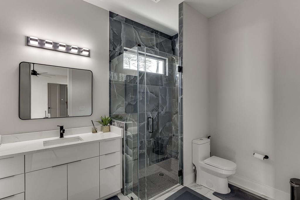 741 Rock Springs Road, Unit 3 Lawrenceville, GA 30043 - Photo 24 of 53 a bathroom with a toilet sink a mirror and shower