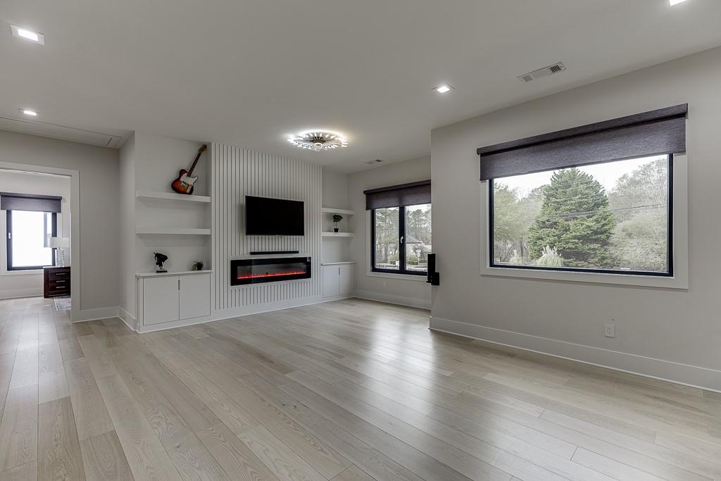 741 Rock Springs Road, Unit 3 Lawrenceville, GA 30043 - Photo 31 of 53 an empty room with wooden floor and windows