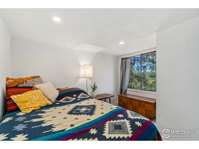 a bedroom with furniture and a window