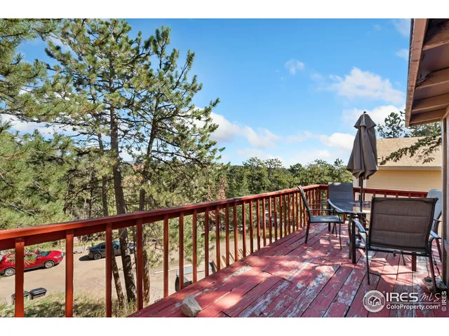 a view of roof deck with chair and wooden floor