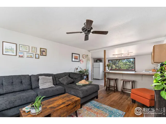 a living room with furniture a window and a potted plant