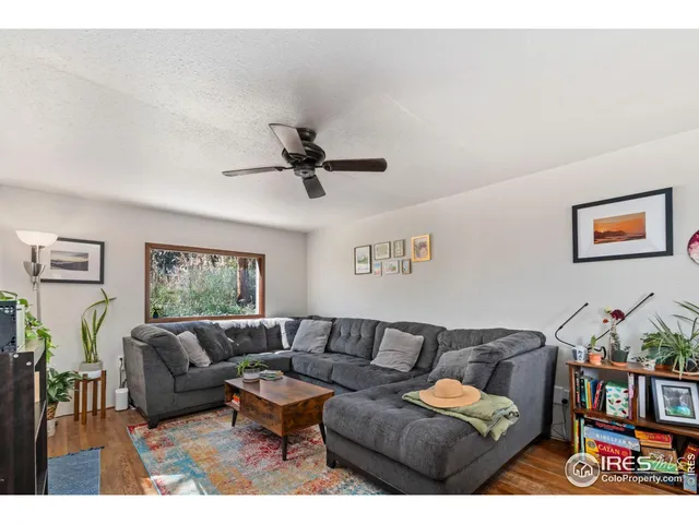 a living room with furniture and a bookshelf