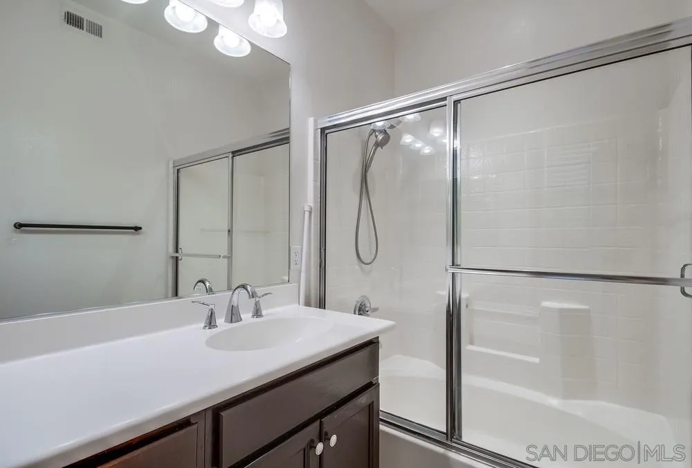 1298 Fools Gold Way, Unit 4 Chula Vista, CA 91913 - Photo 25 of 38 a bathroom with a sink and a mirror