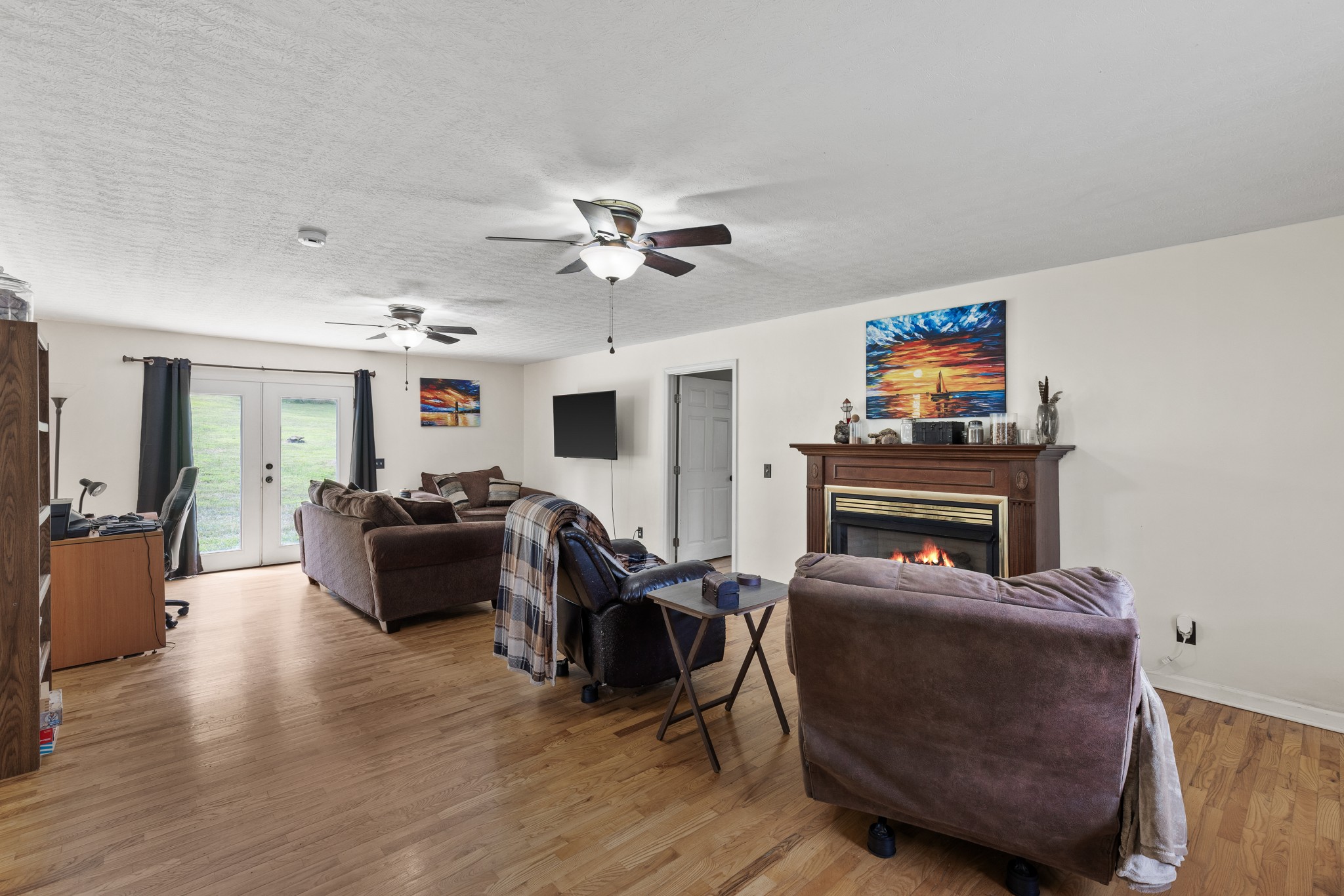2490 Clampit Hollow Road Lafayette, TN 37083 - Photo 12 of 55 a living room with furniture a fireplace and a flat screen tv