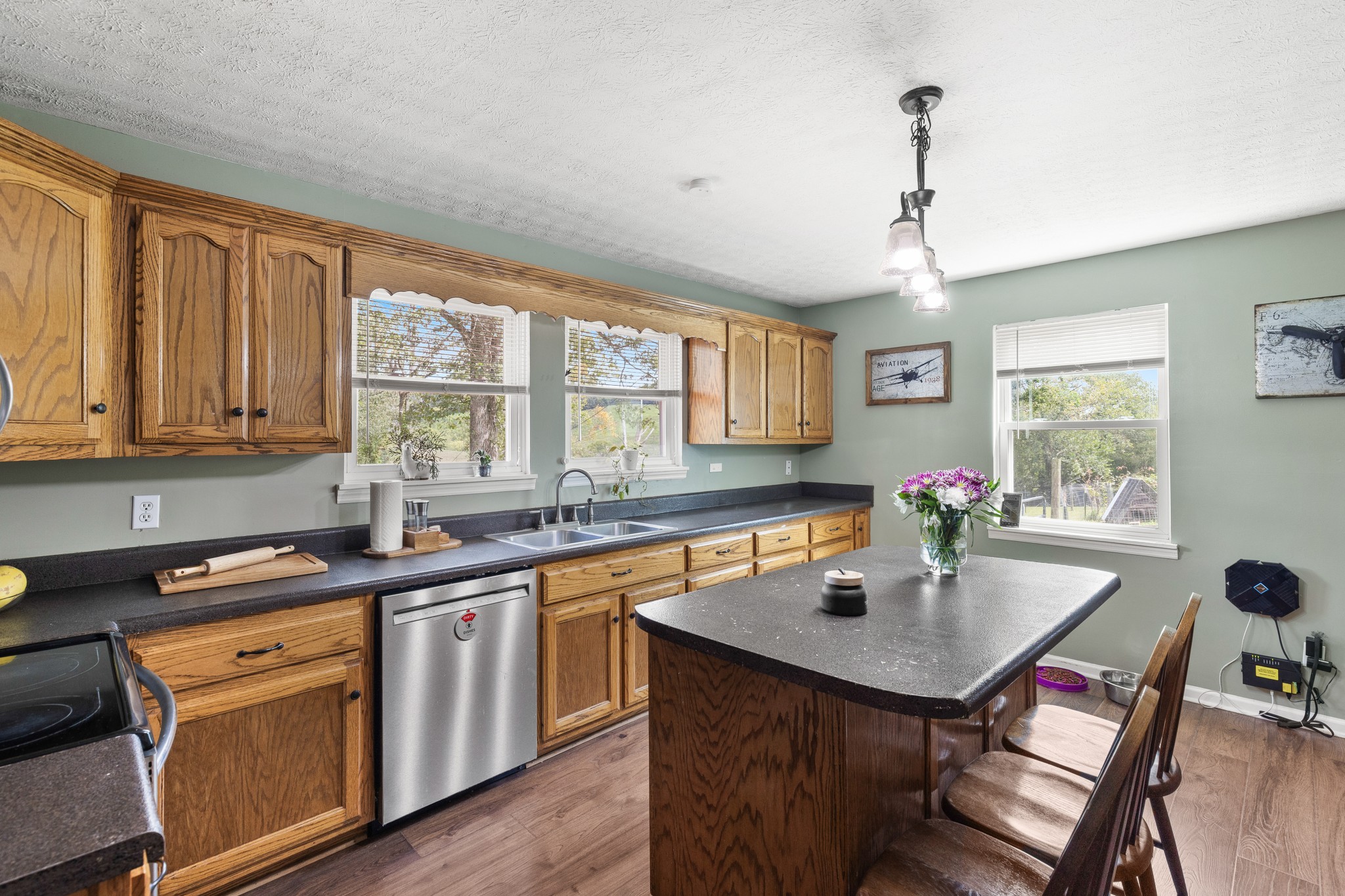 2490 Clampit Hollow Road Lafayette, TN 37083 - Photo 15 of 55 a kitchen with sink dining table and chairs