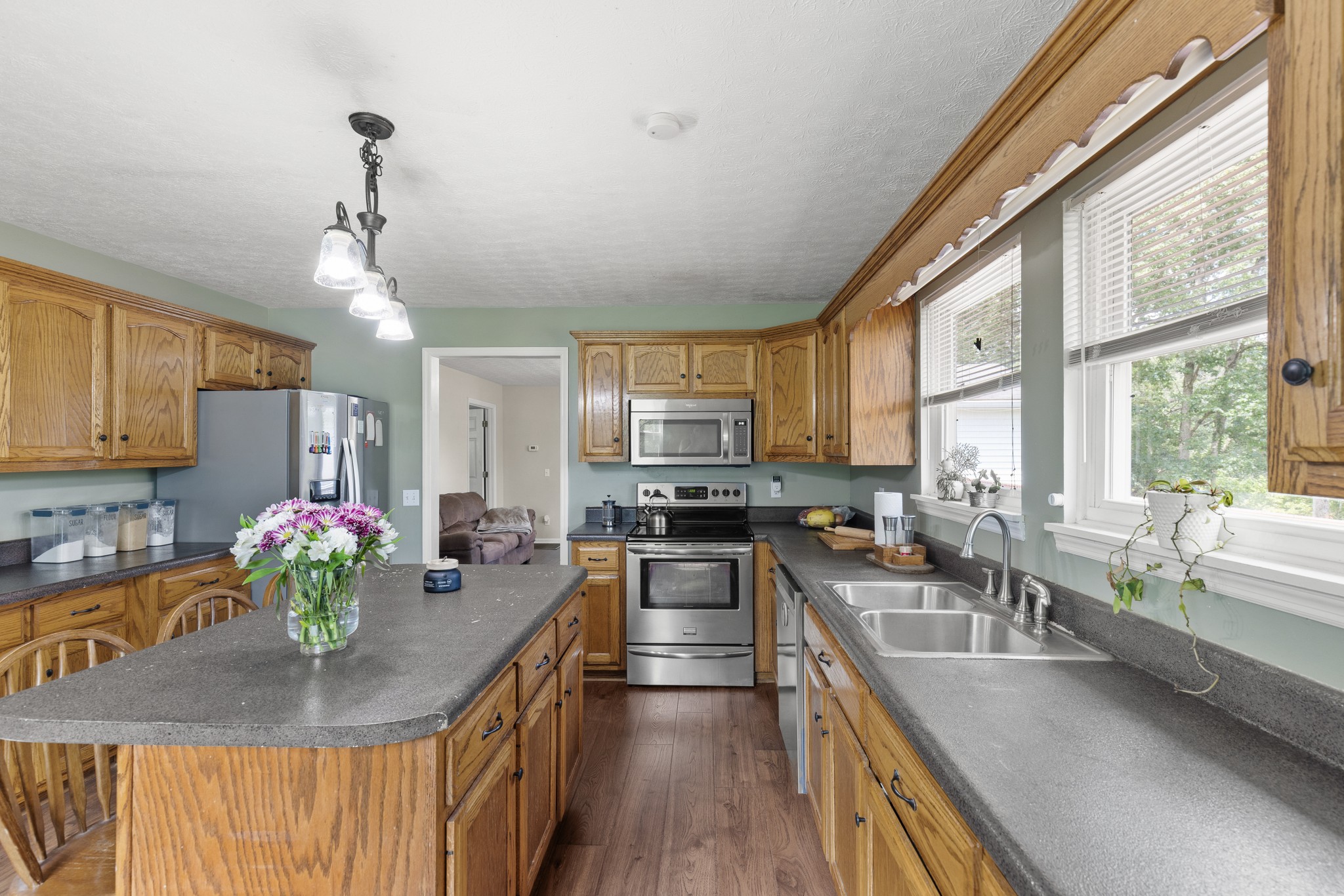 2490 Clampit Hollow Road Lafayette, TN 37083 - Photo 17 of 55 a kitchen with stainless steel appliances granite countertop a stove a sink a oven with a dining table and chairs