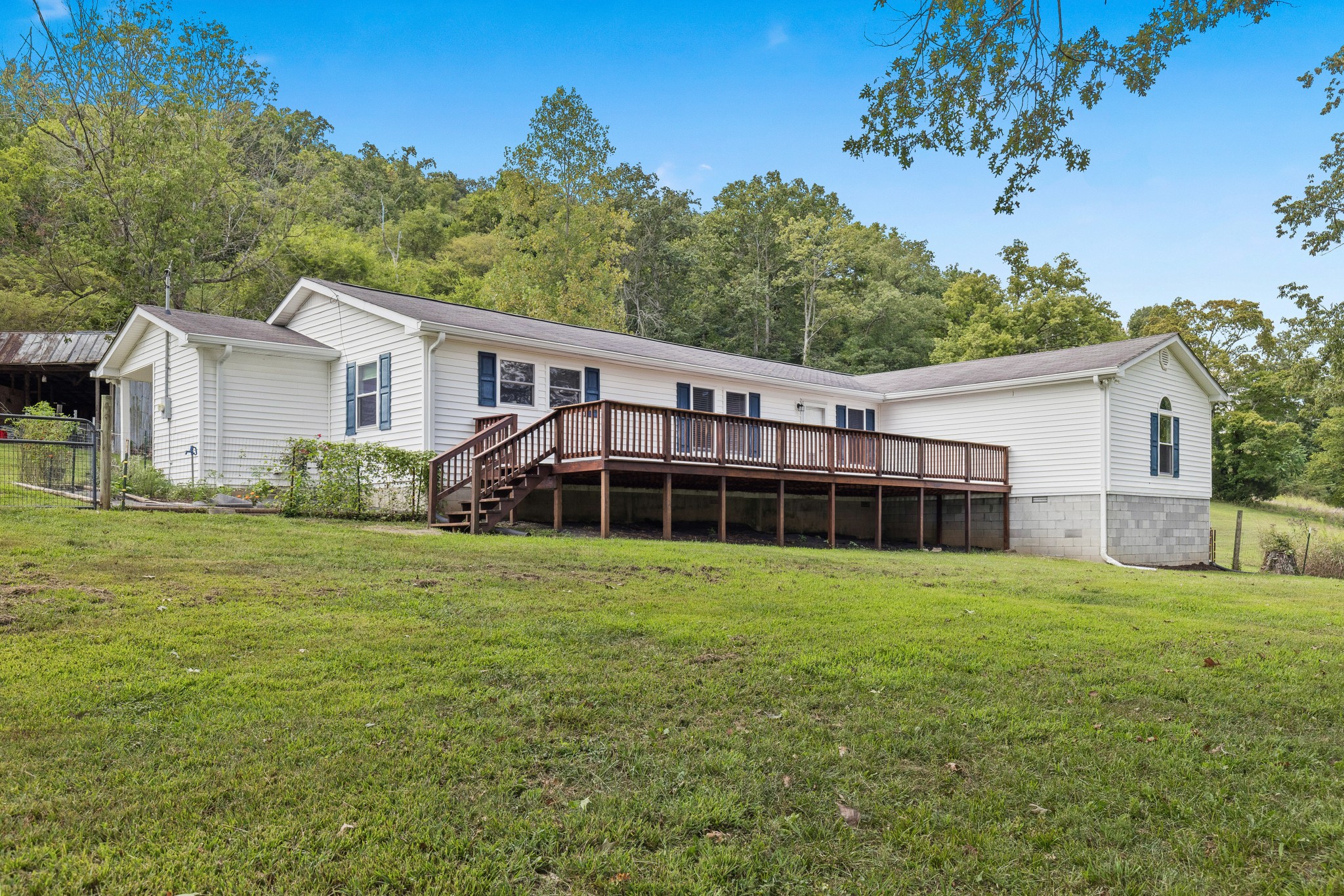 2490 Clampit Hollow Road Lafayette, TN 37083 - Photo 2 of 55 a view of a house with a yard and potted plants