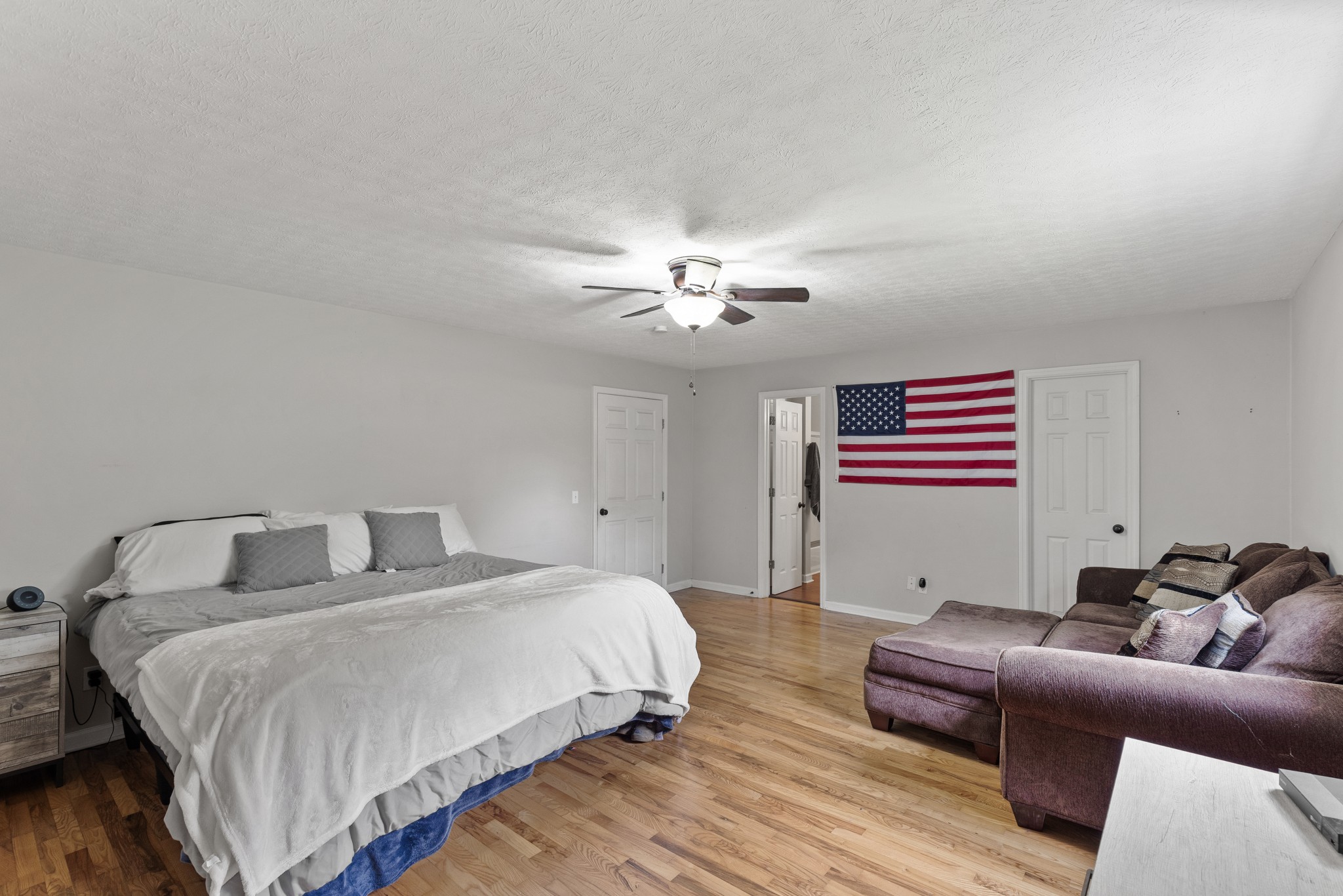 2490 Clampit Hollow Road Lafayette, TN 37083 - Photo 24 of 55 a bedroom with a bed couch and wooden floor