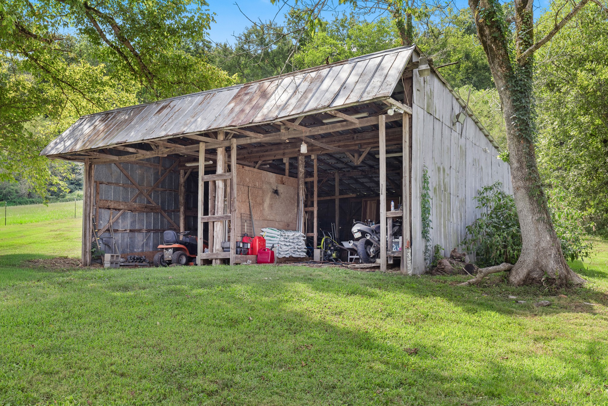 2490 Clampit Hollow Road Lafayette, TN 37083 - Photo 38 of 55 a view of a bedroom with table and chairs under an umbrella