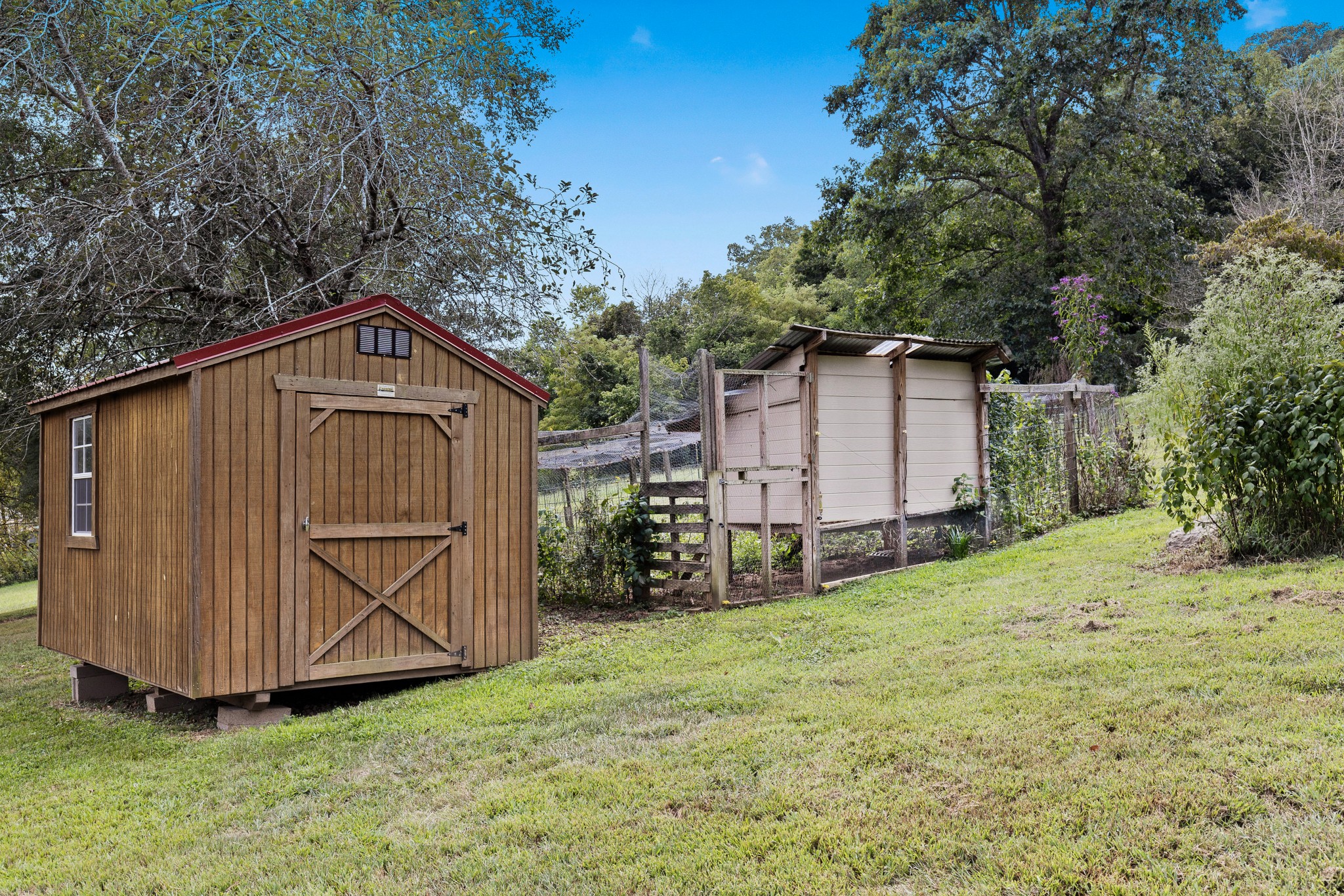 2490 Clampit Hollow Road Lafayette, TN 37083 - Photo 39 of 55 a backyard of a house with garden and deck