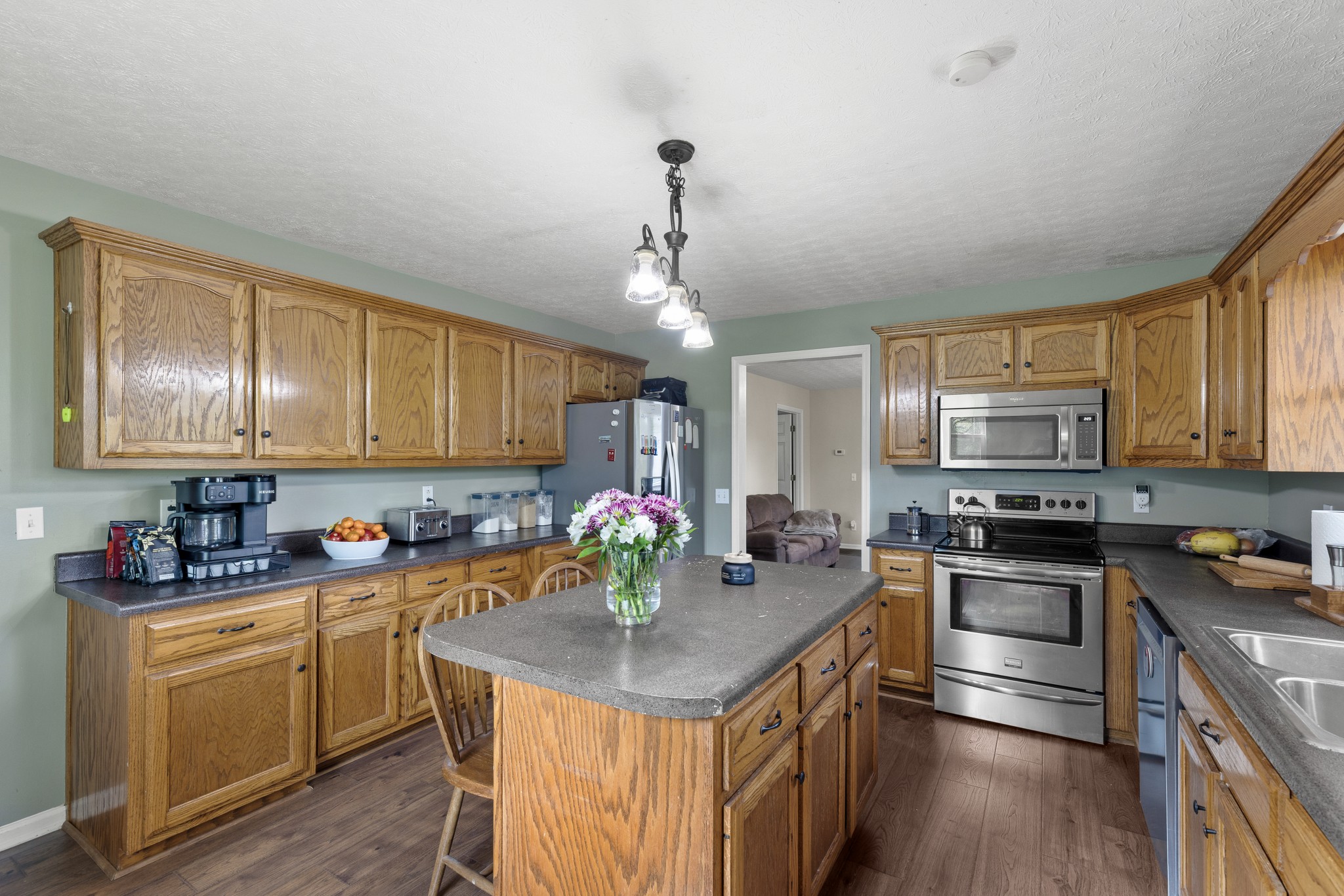 2490 Clampit Hollow Road Lafayette, TN 37083 - Photo 4 of 55 a kitchen with stainless steel appliances granite countertop a sink stove and refrigerator