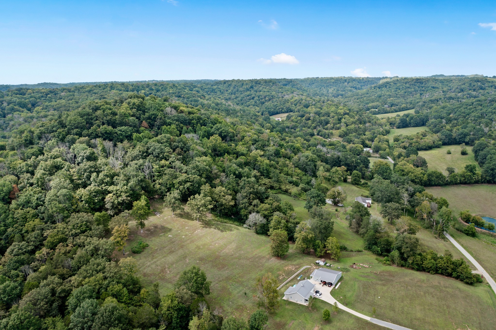 2490 Clampit Hollow Road Lafayette, TN 37083 - Photo 52 of 55 an aerial view of a house with a yard