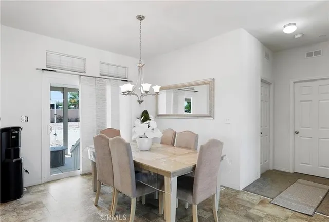 a dining room with furniture and window