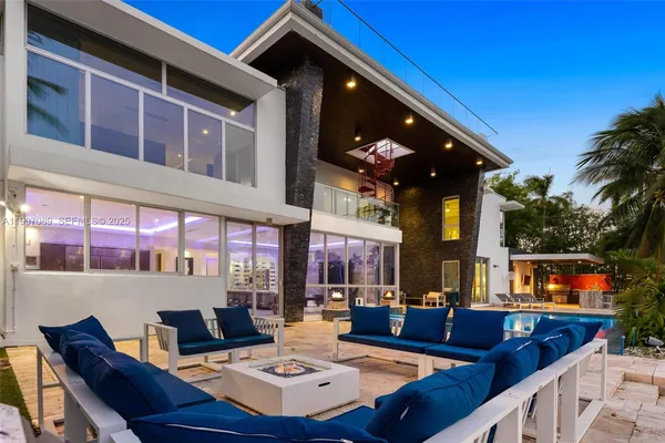 a view of a patio with dining table and chairs with a barbeque grill and couches