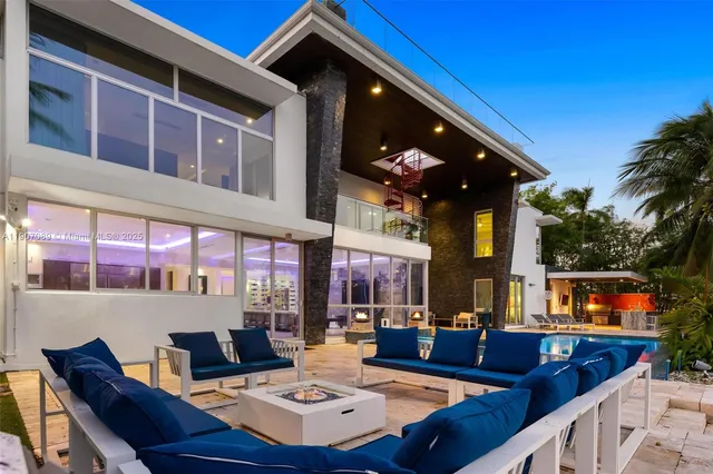 a view of a patio with dining table and chairs with a barbeque grill and couches