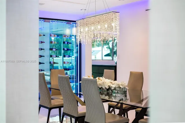 a bedroom with a large bed and a chandelier fan