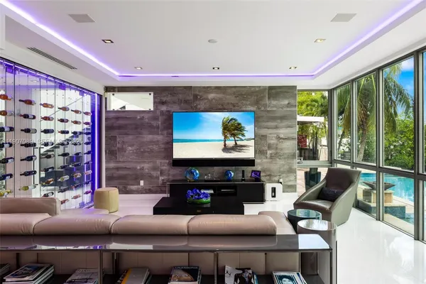 a bathroom with a bathtub a mirror a sink and glass door