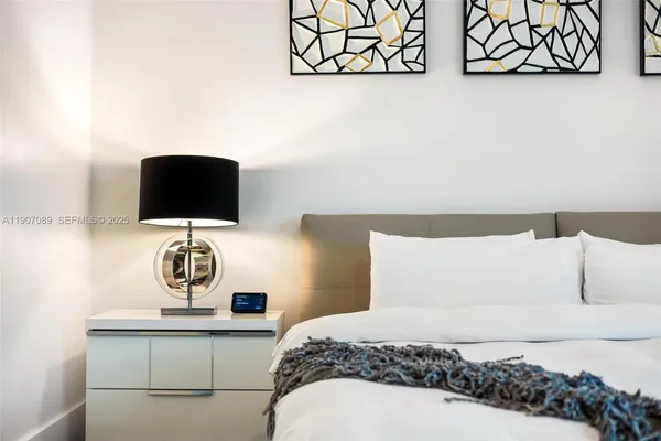 a kitchen with stainless steel appliances granite countertop a sink a stove and a granite counter tops with white cabinets