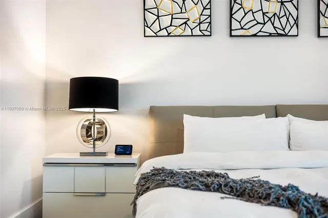 a kitchen with stainless steel appliances granite countertop a sink a stove and a granite counter tops with white cabinets