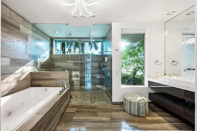 a bedroom with a bed a mirror and a floor to ceiling window