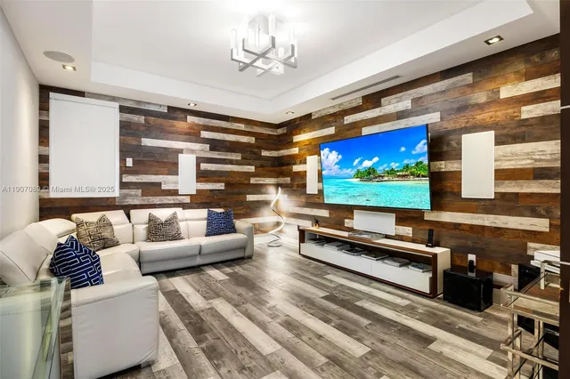 a bedroom with a bed a flat screen tv and a large window