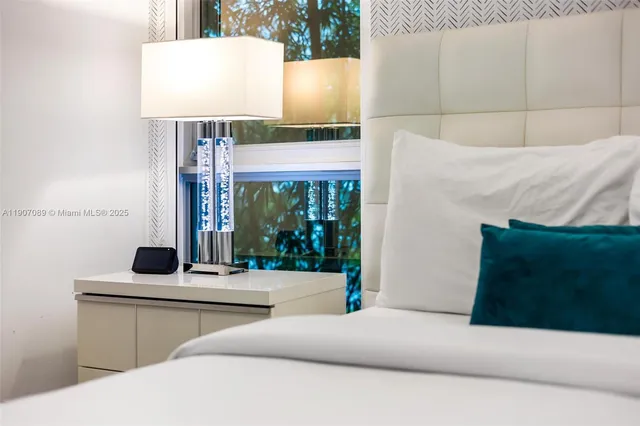 a large white kitchen with stainless steel appliances granite countertop a stove and a sink with cabinets