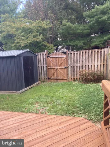 a view of a backyard with wooden fence