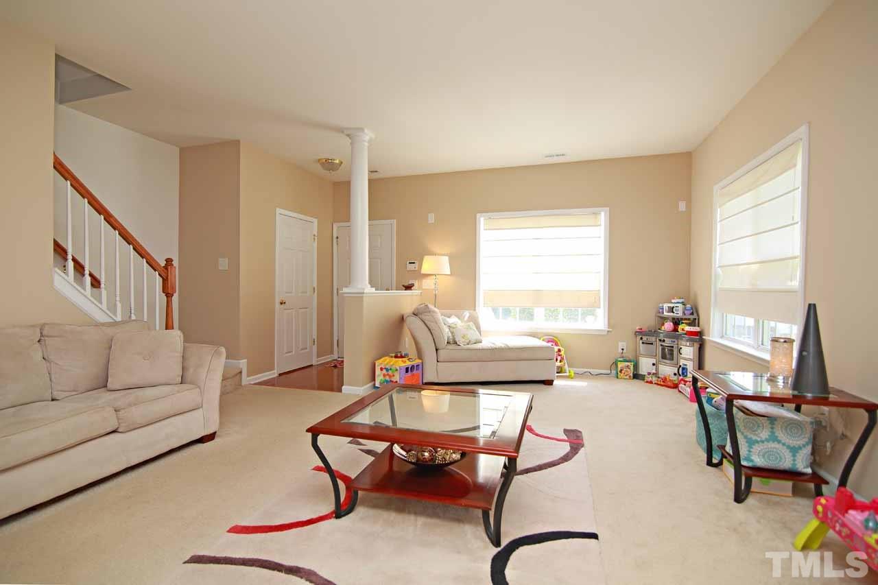 510 Huron Road Raleigh, NC 27610 - Photo 2 of 13 a living room with furniture a rug and a window