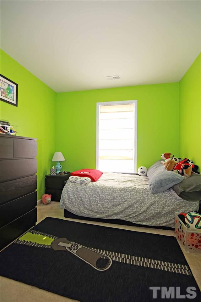 510 Huron Road Raleigh, NC 27610 - Photo 11 of 13 a bedroom with a bed and a window