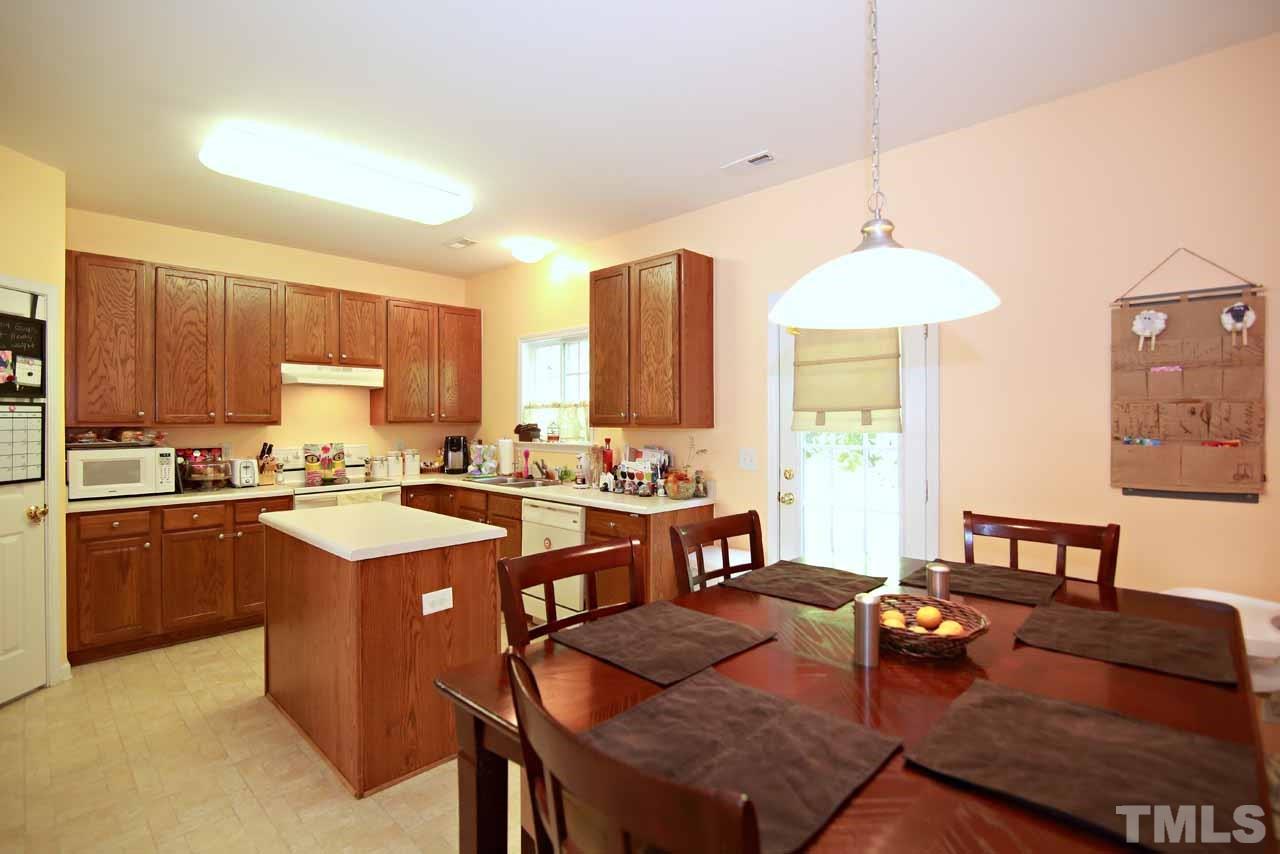 510 Huron Road Raleigh, NC 27610 - Photo 4 of 13 a open kitchen with stainless steel appliances granite countertop a stove a sink dishwasher and a dining table with granite countertops