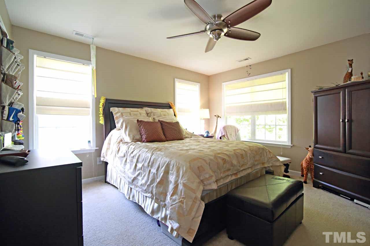 510 Huron Road Raleigh, NC 27610 - Photo 6 of 13 a bedroom with a bed couch and window