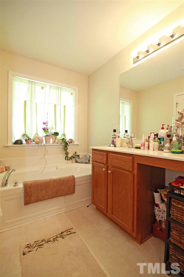 510 Huron Road Raleigh, NC 27610 - Photo 7 of 13 a bathroom with a tub sink and mirror