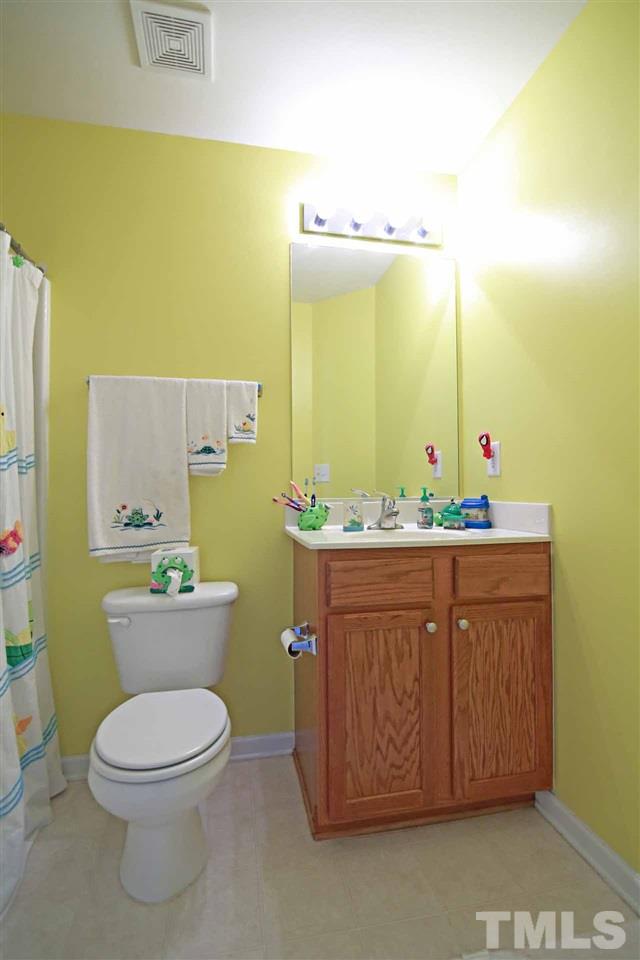 510 Huron Road Raleigh, NC 27610 - Photo 9 of 13 a bathroom with a granite countertop toilet sink and mirror