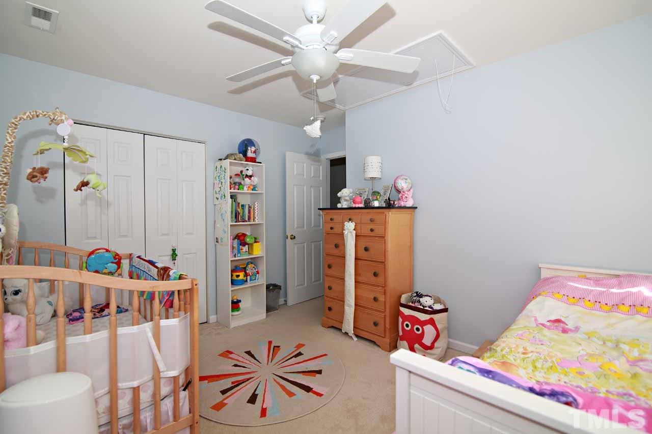 510 Huron Road Raleigh, NC 27610 - Photo 10 of 13 a bedroom with furniture and a bed
