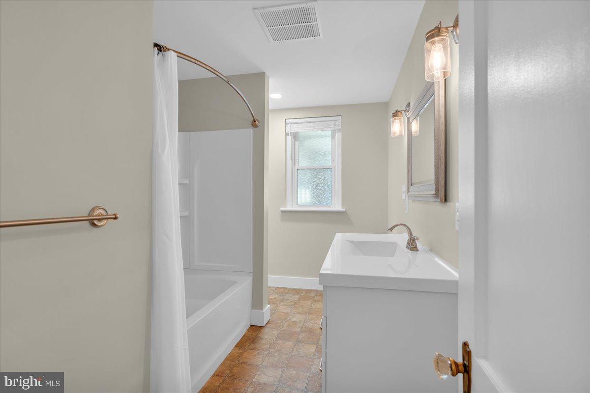 217 South Main Street Elmer, NJ 08318 - Photo 12 of 25 a bathroom with a sink and a mirror